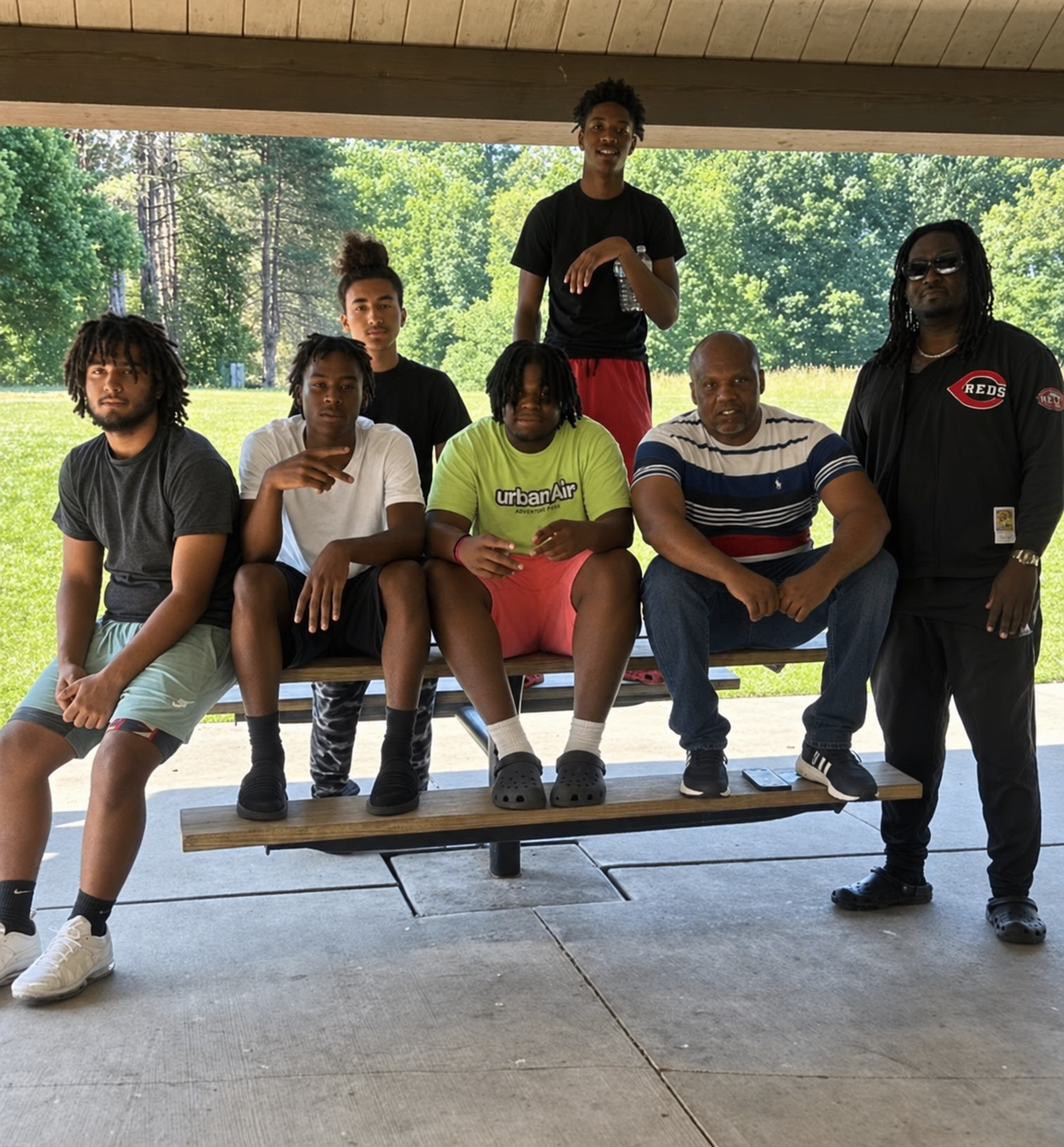 Marcel McDaniel and Attorney Imokhai Okolo with participants after a community legal workshop for young Black men.
