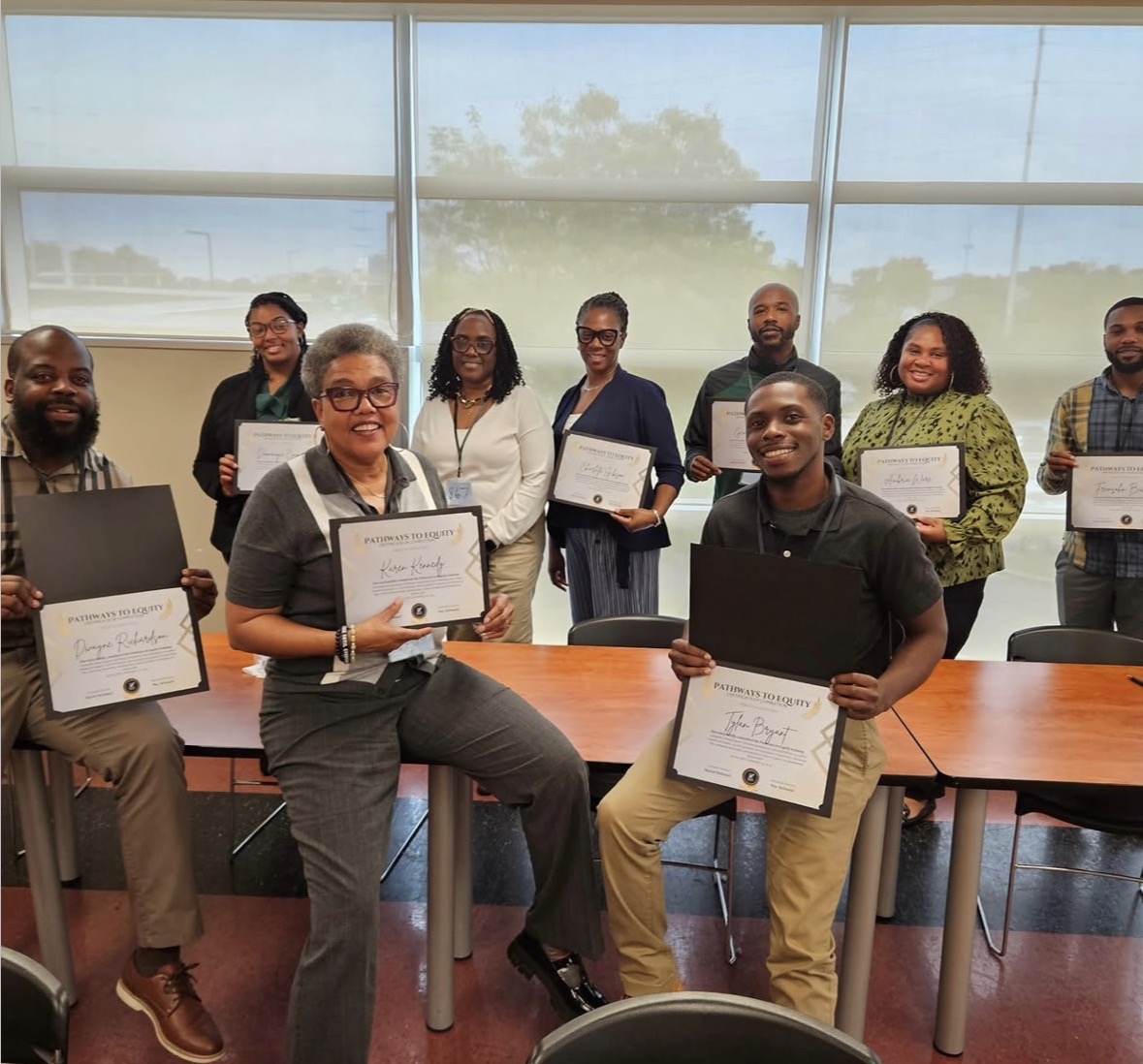 Members of the Akron Urban League leadership team hold Pathways to Equity completion certificates.
