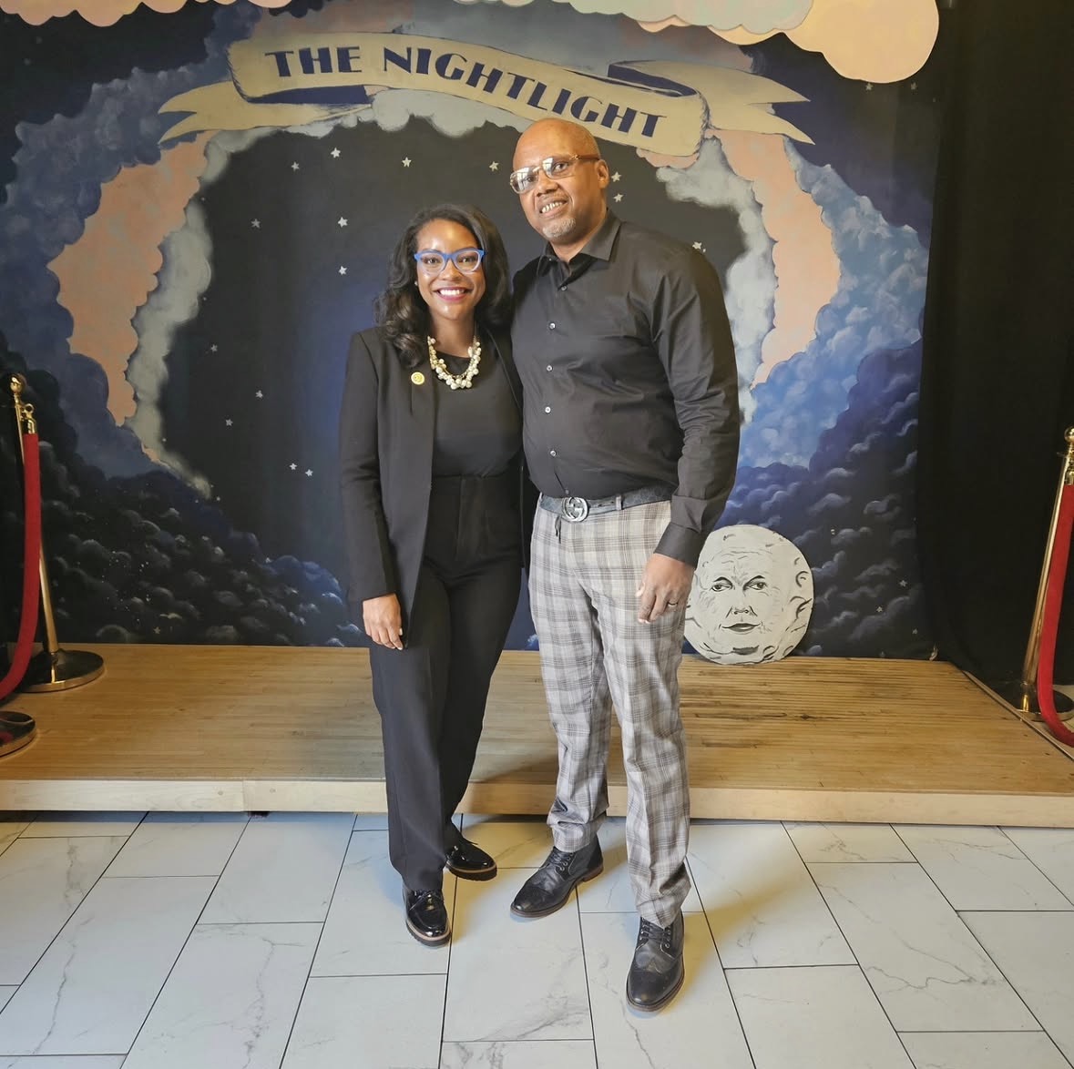 Congresswoman Emilia Sykes and Marcel McDaniel standing together at a private documentary screening.